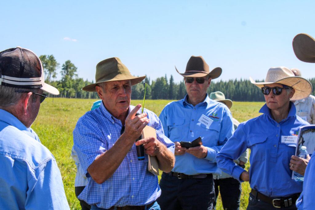 Kim Nielsen demonstrates to visiting producers at 4 Clover Ranch about his pastures soil health and grazing techniques.